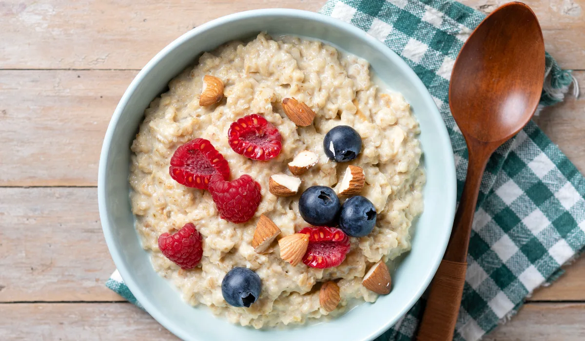 Overnight oats in a glass jar topped with fresh berries and chia seeds