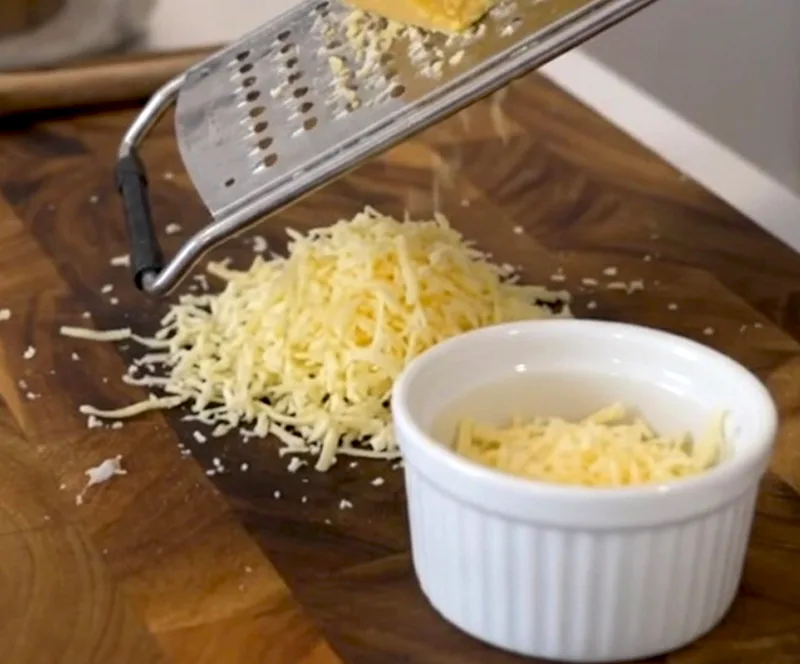 Use the strongest cheddar you can find — and grate it yourself