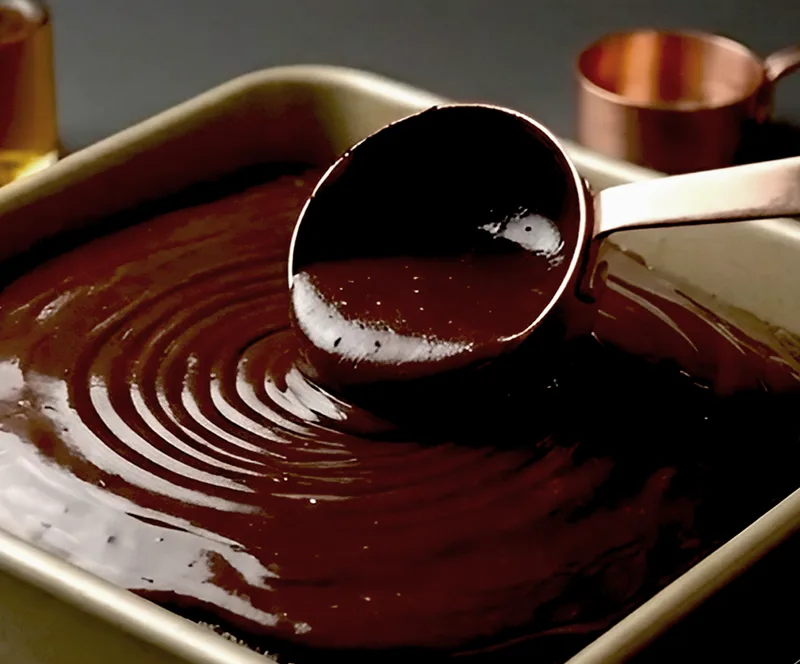 Make the ganache while the cake is still in the tin